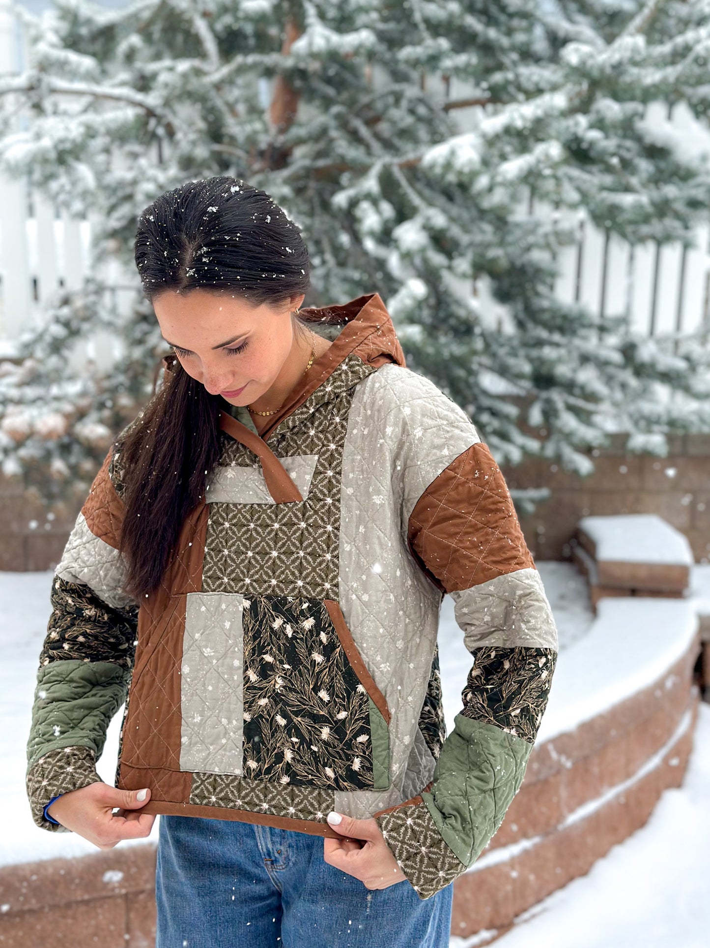 Woman wearing a quilted winter jacket in a snowy outdoor setting