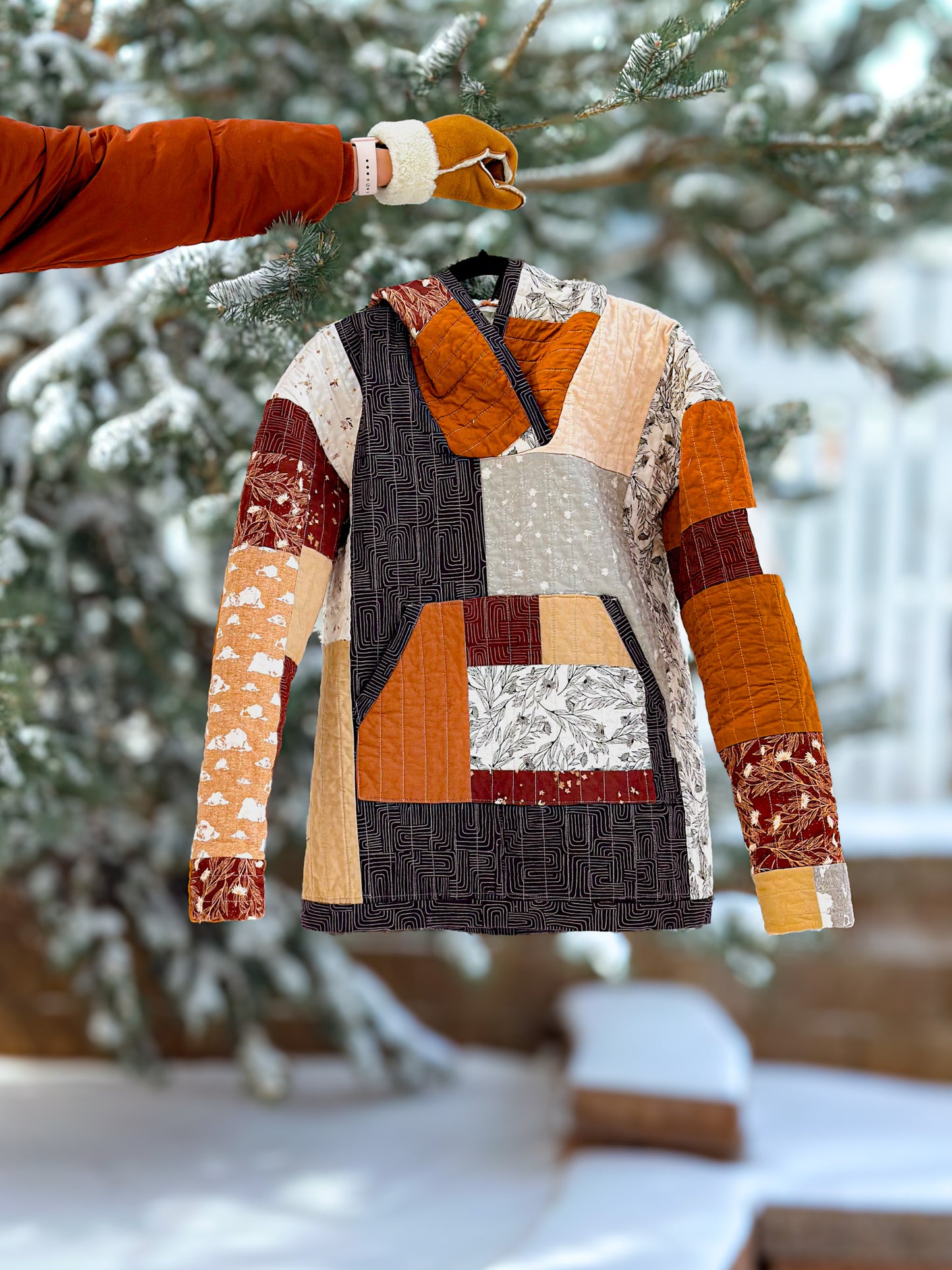Patchwork quilted jacket on a stand with a snowy background
