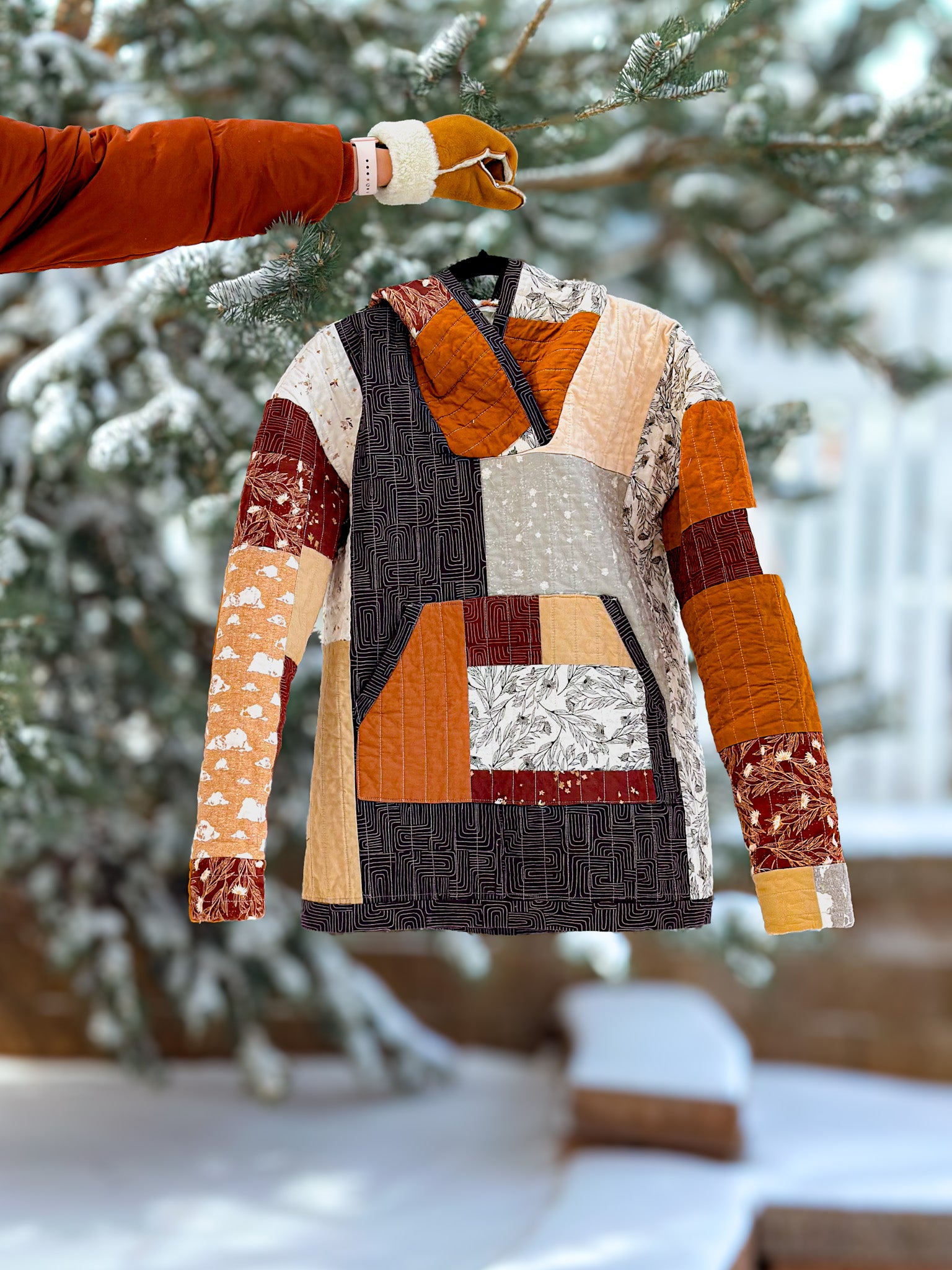 Patchwork quilted jacket on a stand with a snowy background